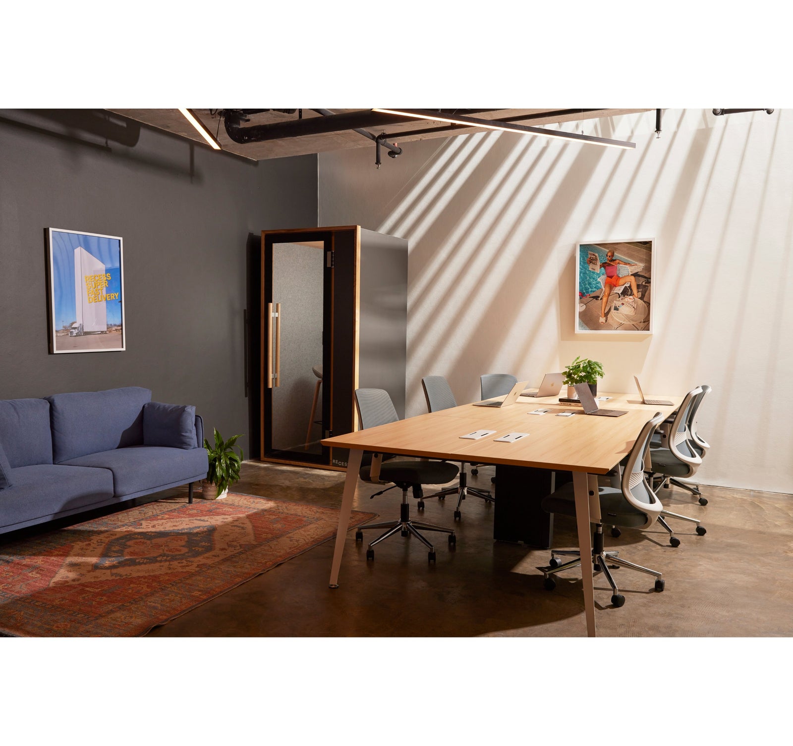 Recess stand up desk with ergo chair and small pot plants in corner of screen