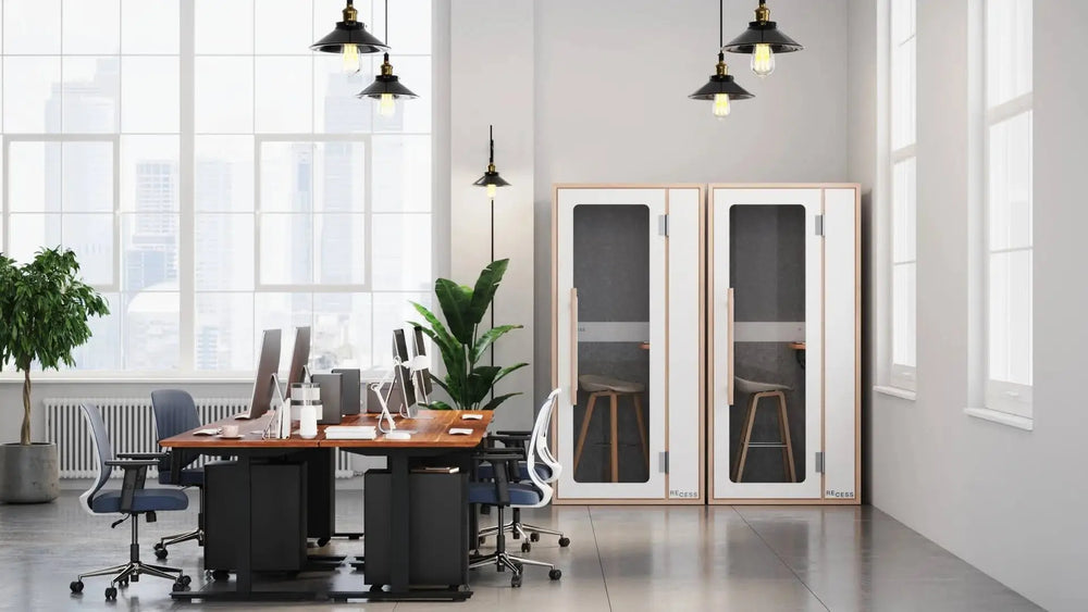Open plan office with soundproof booths that support the benefits of a quiet room at work