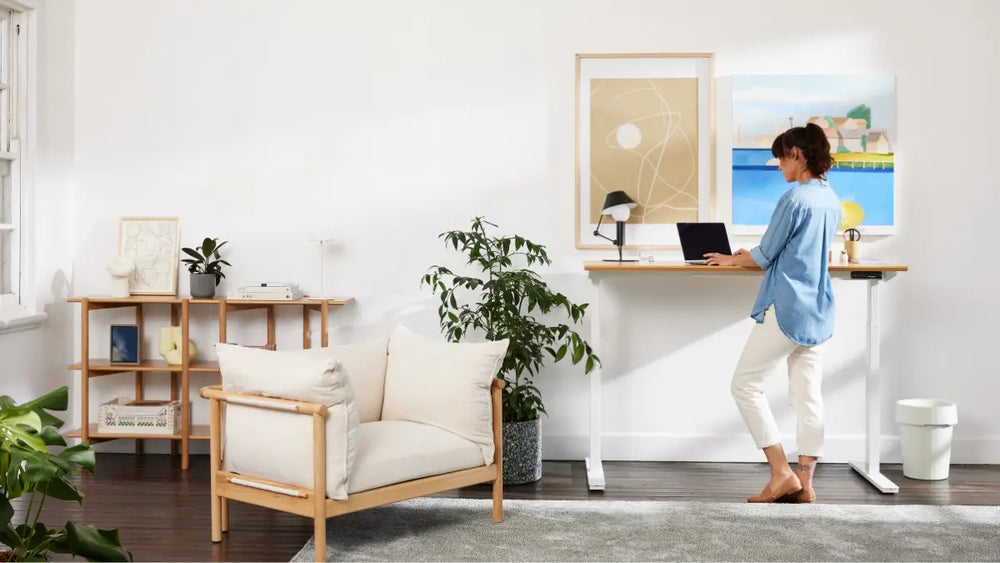 Person standing and working at a standing desk during a microbreak