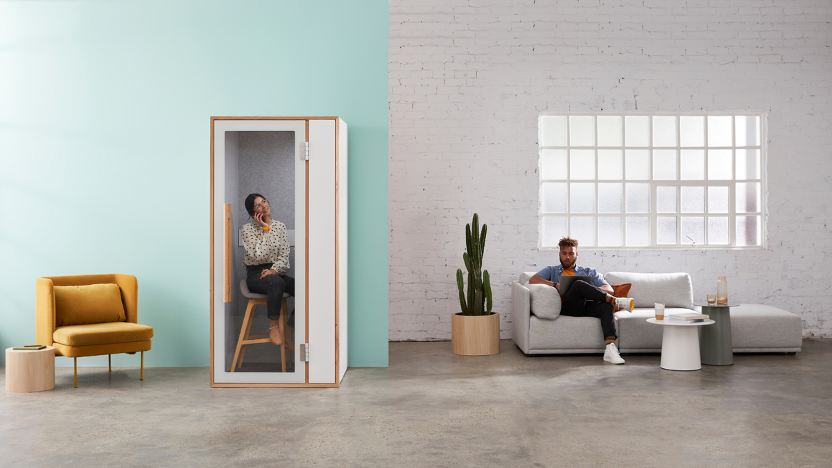 Woman making a phone call inside The Nook soundproof booth