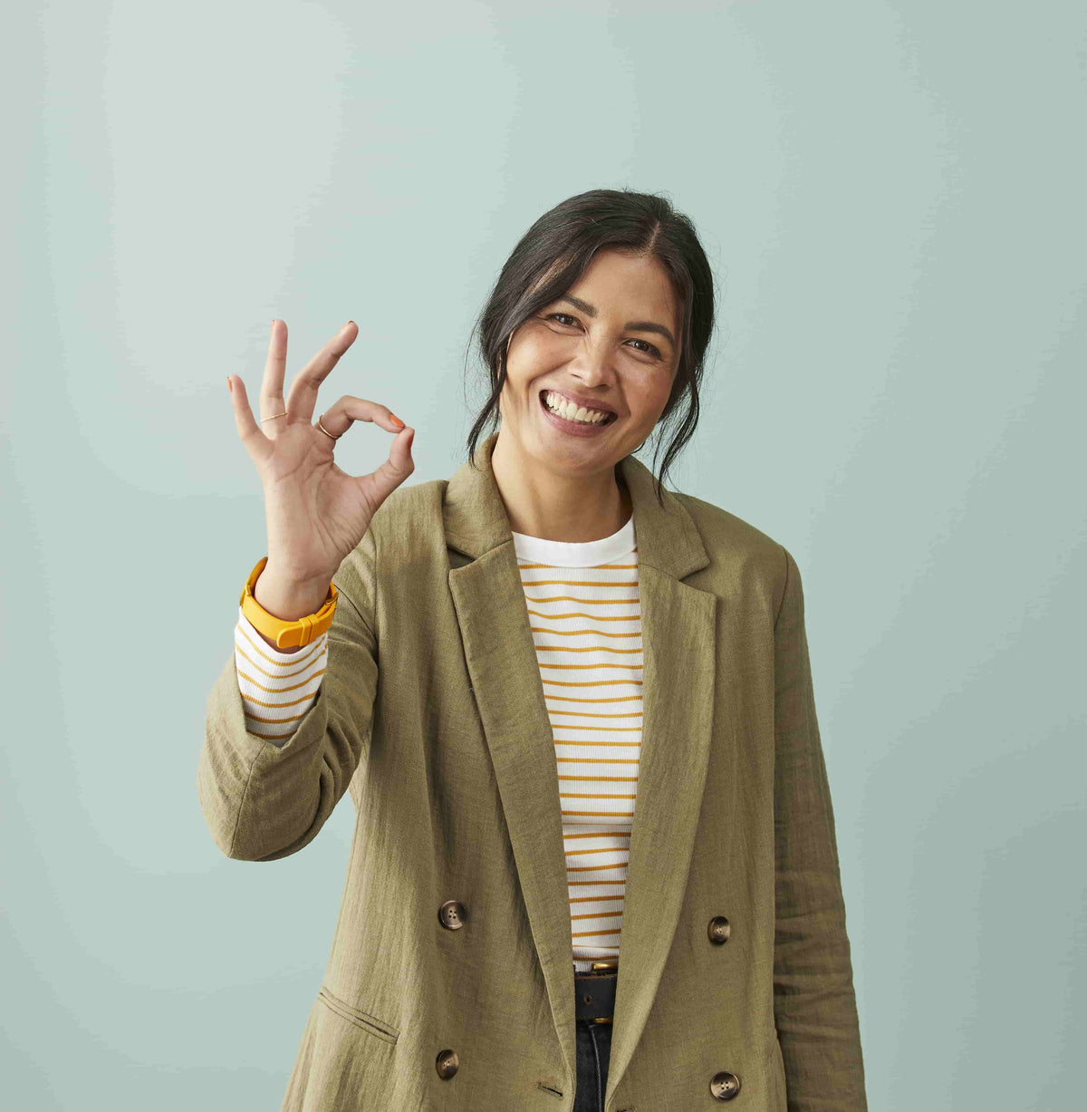 Smiling woman giving an OK sign for the Australian-certified and compliant soundproof booth