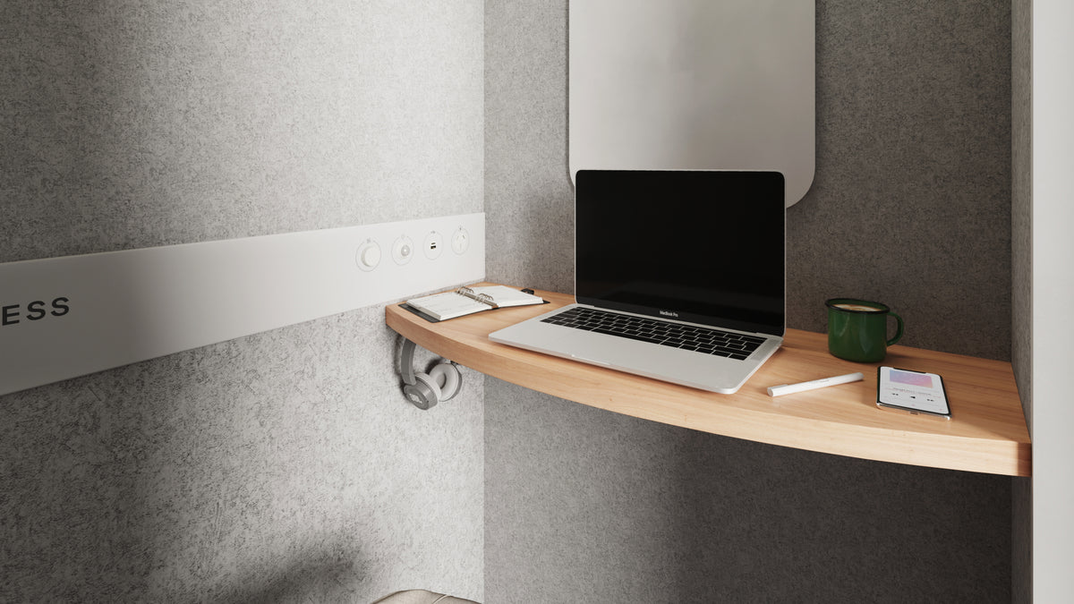 Inside the soundproof booth showing built-in desk for laptop, with USB ports and AU power points