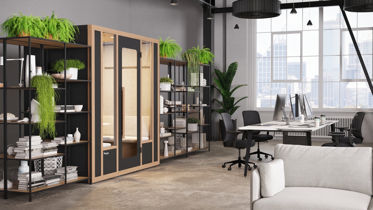 Recess Cove meeting booth integrated into a contemporary workspace surrounded by open shelving with plants and office desks